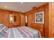 Bright bedroom featuring wood walls and a striped comforter at 22649, 22645 And Tbd Ne 105Th Avenue Rd, Fort Mc Coy, FL 32134