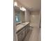 Bathroom with double vanity, tub, and light gray cabinets at 7830 Sw 103Rd Loop, Ocala, FL 34476