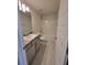 Bathroom with single vanity, tub shower combo, and gray cabinets at 7830 Sw 103Rd Loop, Ocala, FL 34476