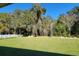 Large backyard with grassy area and natural wooded backdrop at 7830 Sw 103Rd Loop, Ocala, FL 34476