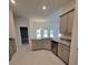 Spacious kitchen with light gray cabinets and granite countertops at 7830 Sw 103Rd Loop, Ocala, FL 34476