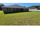 Gray house exterior with large backyard and patio at 7830 Sw 103Rd Loop, Ocala, FL 34476