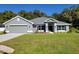 Modern two-story house with gray exterior and two-car garage at 7830 Sw 103Rd Loop, Ocala, FL 34476