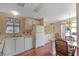 Bright kitchen features white cabinets, wood flooring, and a breakfast bar at 1618 Cypress Pt, Lady Lake, FL 32159