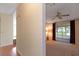 Bright living room with hardwood floors and sliding glass doors leading to a sunroom at 1618 Cypress Pt, Lady Lake, FL 32159
