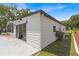 White house exterior with sliding glass doors and a spacious patio at 1618 Cypress Pt, Lady Lake, FL 32159