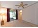 Spacious bedroom with ceiling fan, sliding glass doors to a sunroom and ample closet space at 1618 Cypress Pt, Lady Lake, FL 32159
