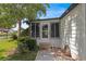 Inviting front entry with a screened porch and landscaped walkway at 1618 Cypress Pt, Lady Lake, FL 32159