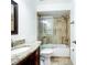Bathroom with tub and shower, granite countertop, and updated fixtures at 16290 Sw 17Th Ave, Ocala, FL 34473