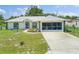 House exterior with screened garage and driveway at 16290 Sw 17Th Ave, Ocala, FL 34473