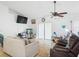 Living room with ceiling fan, tiled floor, and sliding glass doors at 16290 Sw 17Th Ave, Ocala, FL 34473