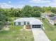 Single-story home with screened-in garage, fenced yard, and mature trees at 16290 Sw 17Th Ave, Ocala, FL 34473
