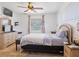 Main bedroom with large window, dresser, and ceiling fan at 16290 Sw 17Th Ave, Ocala, FL 34473