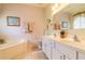 Bathroom with double vanity, soaking tub, and shower at 2291 Nw 59Th Ter, Ocala, FL 34482