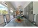 Bright enclosed patio with a large dining table and seating at 2291 Nw 59Th Ter, Ocala, FL 34482