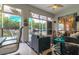 This screened patio has both seating and dining areas and opens to a backyard at 2291 Nw 59Th Ter, Ocala, FL 34482
