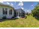Spacious screened porch with patio furniture and lush landscaping at 2291 Nw 59Th Ter, Ocala, FL 34482