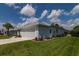 White garage with screen door and landscaping along the side at 2291 Nw 59Th Ter, Ocala, FL 34482