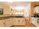 White kitchen cabinets, granite countertops, and a dishwasher are featured at 2291 Nw 59Th Ter, Ocala, FL 34482