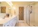 Bathroom boasting double sinks, shower, and access to another room at 2291 Nw 59Th Ter, Ocala, FL 34482