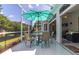Large screened patio with dining area and partial view of the living room at 2291 Nw 59Th Ter, Ocala, FL 34482