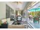 Relaxing enclosed patio with seating area and outdoor dining at 2291 Nw 59Th Ter, Ocala, FL 34482