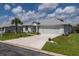 Single-story house with a two-car garage and a nicely landscaped yard at 2291 Nw 59Th Ter, Ocala, FL 34482