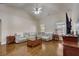 Spacious living room with hardwood floors, sectional sofa, and built-in shelving at 4320 Se 106Th St, Belleview, FL 34420