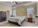 Main bedroom with a large bed, nightstand and a safe at 4320 Se 106Th St, Belleview, FL 34420
