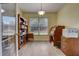 Bright home office features built-in shelving and a large desk at 4320 Se 106Th St, Belleview, FL 34420