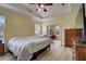Main bedroom with large bed, ceiling fan, and wood furniture at 4320 Se 106Th St, Belleview, FL 34420