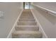 Indoor carpeted staircase with simple white railing at 4320 Se 106Th St, Belleview, FL 34420