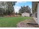 Spacious backyard offering a grassy area, storage shed, and mature trees at 4320 Se 106Th St, Belleview, FL 34420
