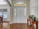 Bright entryway with hardwood floors and a wooden console table at 4320 Se 106Th St, Belleview, FL 34420