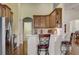 Kitchen boasts wood cabinets, stainless steel appliances, and an island with seating at 4320 Se 106Th St, Belleview, FL 34420