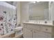 Bright bathroom with white vanity and floral shower curtain at 4320 Se 106Th St, Belleview, FL 34420