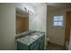 Updated bathroom with granite countertop and blue vanity at 535 W Silver Springs Pl, Ocala, FL 34475