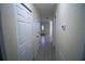 Bright hallway with tile flooring and neutral walls at 535 W Silver Springs Pl, Ocala, FL 34475