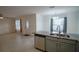 Open concept kitchen with granite countertops and stainless steel appliances at 535 W Silver Springs Pl, Ocala, FL 34475
