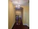 Elegant hallway with hardwood floors and chandelier at 6895 Se 96Th Place Rd, Belleview, FL 34420