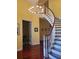 Elegant curved staircase with chandelier in entryway at 6895 Se 96Th Place Rd, Belleview, FL 34420