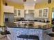 Kitchen with breakfast bar and mosaic backsplash at 6895 Se 96Th Place Rd, Belleview, FL 34420