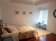 Bright bedroom with a king-size bed and hardwood floors at 6895 Se 96Th Place Rd, Belleview, FL 34420