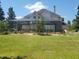 Screened patio, lush landscaping, and large yard at 6895 Se 96Th Place Rd, Belleview, FL 34420
