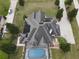 Aerial view showing home with pool, solar panels, and large yard at 6895 Se 96Th Place Rd, Belleview, FL 34420