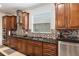 Spacious kitchen with dark wood cabinets, granite countertops, and stainless steel appliances at 6701 Sw 94Th Cir, Ocala, FL 34481