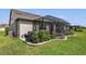 Landscaped backyard with a screened patio and grill at 6701 Sw 94Th Cir, Ocala, FL 34481