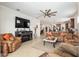 Open living room featuring a fireplace, leather furniture and kitchen views at 6701 Sw 94Th Cir, Ocala, FL 34481
