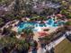 Aerial view of a large community pool with surrounding palm trees and lounge chairs at 6701 Sw 94Th Cir, Ocala, FL 34481