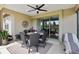 Relaxing screened porch with patio furniture and ceiling fan at 6701 Sw 94Th Cir, Ocala, FL 34481